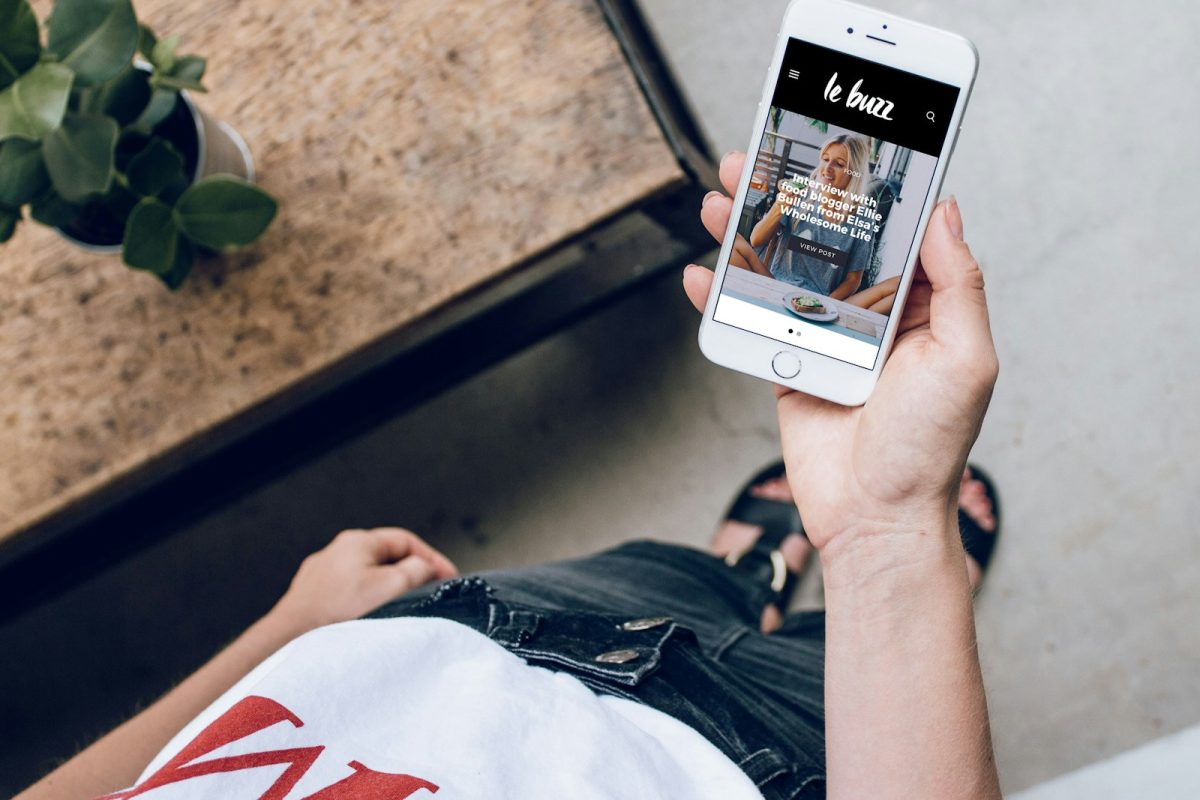 person holding silver iPhone 6 near green leaf plant